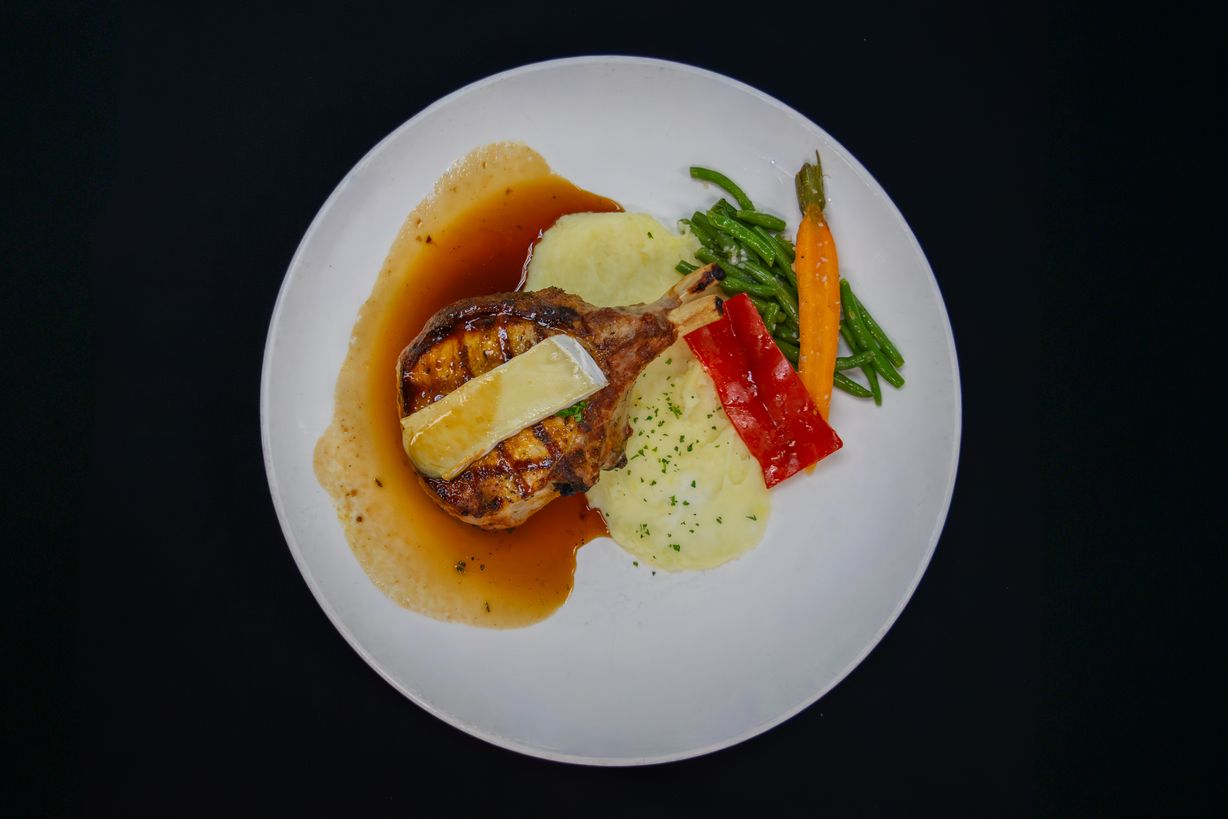 12 Oz Bone In Porkchop at Marigold Bistro in Colorado Springs, CO 80906 | YourMenu® Online Ordering