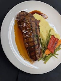12 Oz Grilled New York Strip at Marigold Bistro in Colorado Springs, CO 80906 | YourMenu® Online Ordering