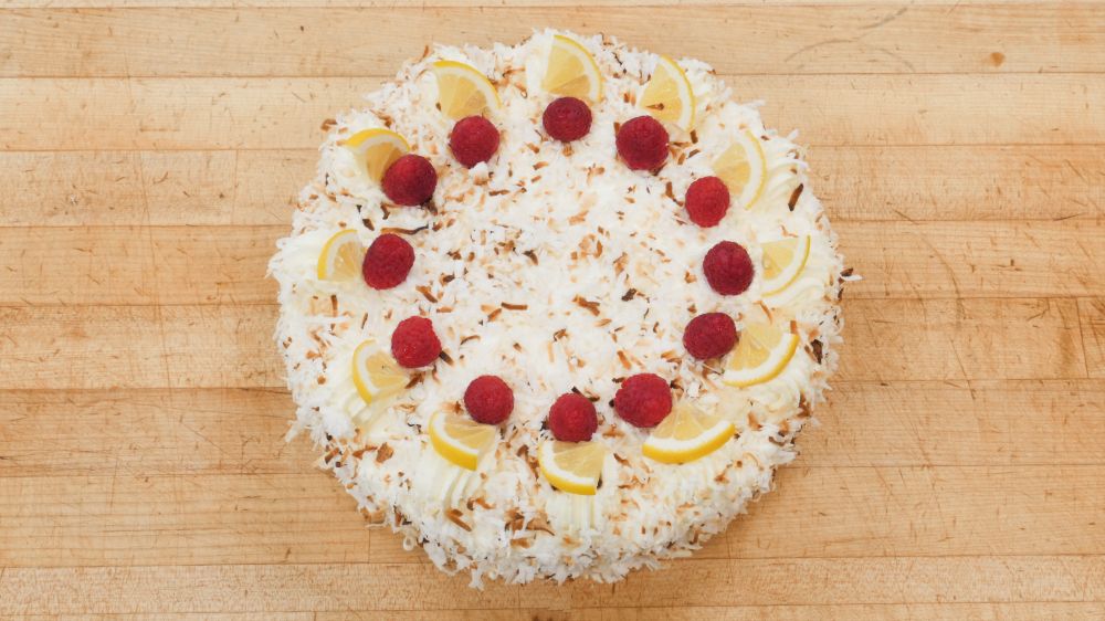 Coconut La Raz Cake at Marigold Cafe & Bakery - Cake Menu in Colorado Springs, CO 80919 | YourMenu® Online Ordering
