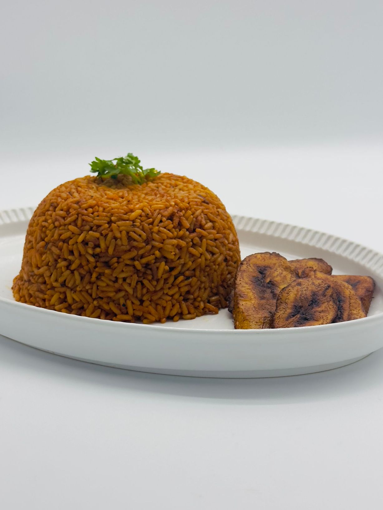 Jollof Rice with plantain at Dextera 9ja Cuisine in Middletown, MD 21769 | YourMenu® Online Ordering
