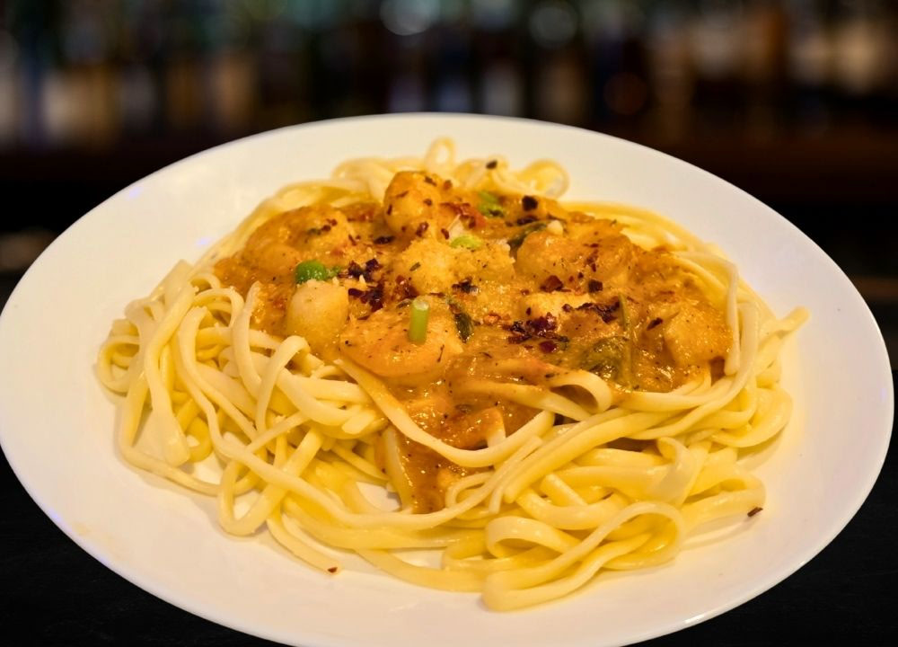 Cajun Seafood Pasta / Pasta cajún con mariscos at Andrew's Restaurant in Suitland, MD 20746 | YourMenu® Online Ordering